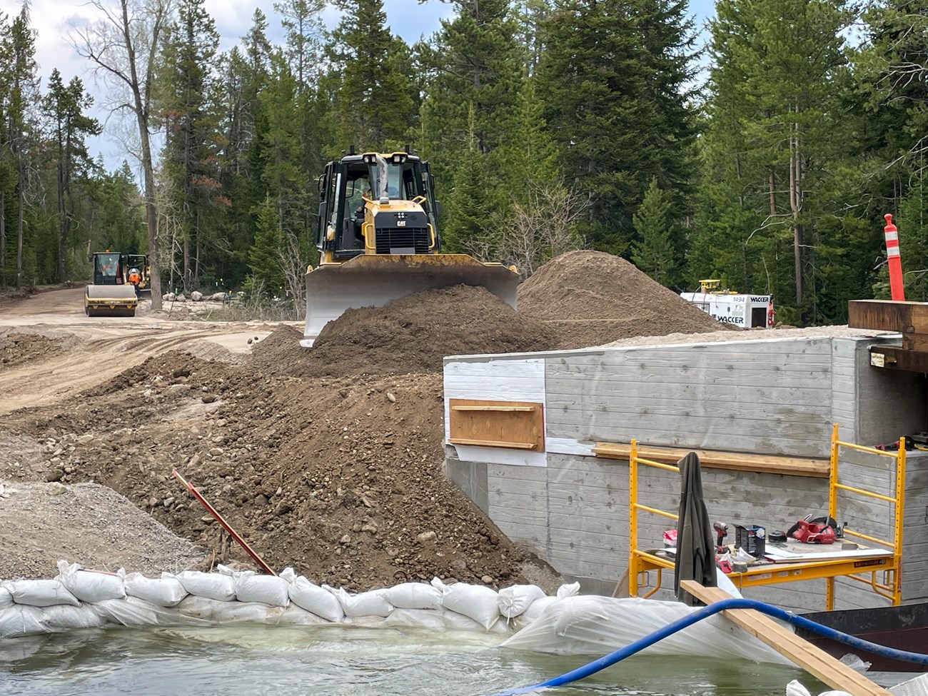 Dozer installing backfill at north bridge abutment, Kaufman Creek, along the Moose-Wilson Road