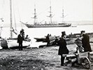 Men in top hats pose with boats near Alexandria's wharf