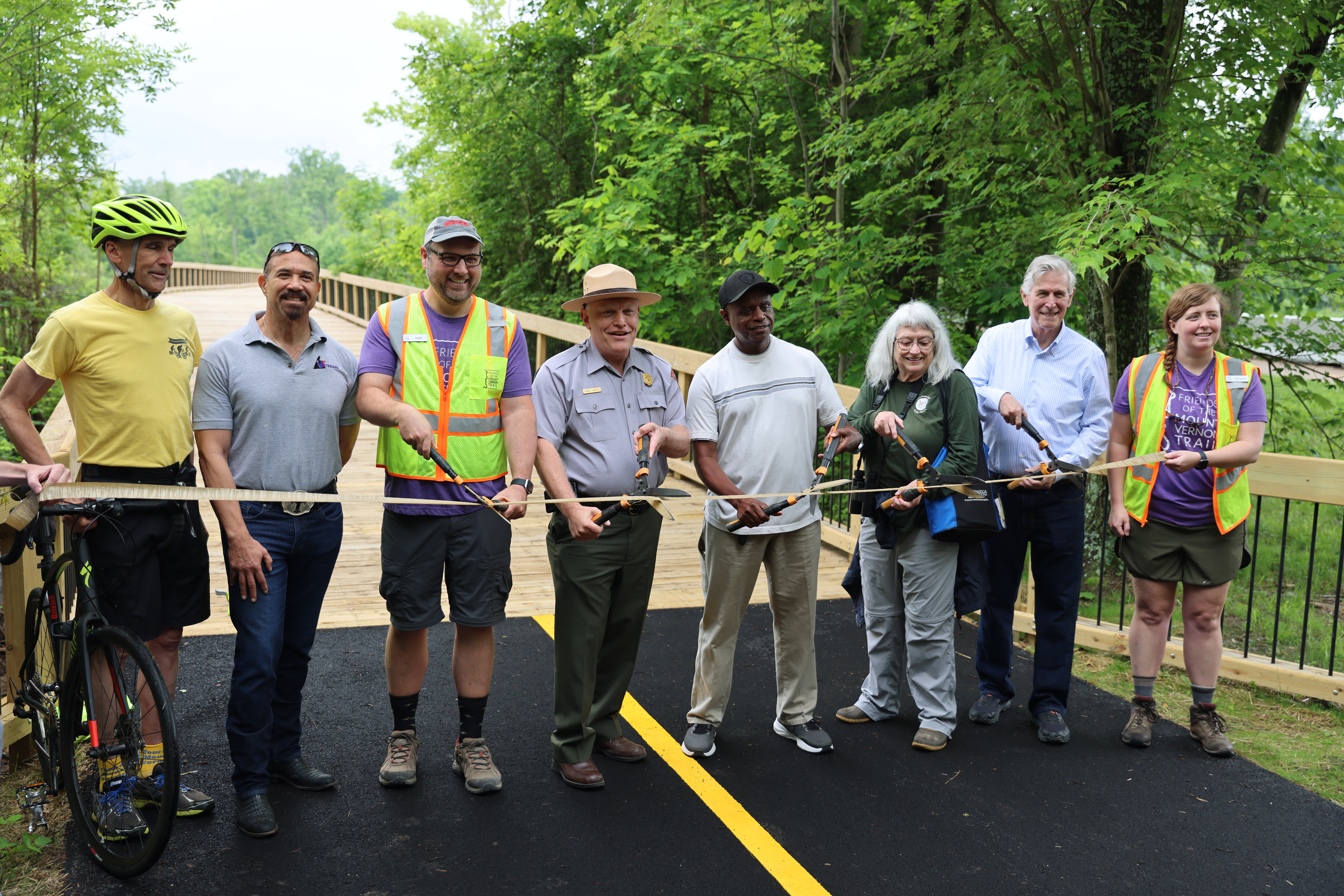 Park staff and partners cutting a ribbon.