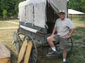 Jim Koenig stands in front of the wagon he repaired.