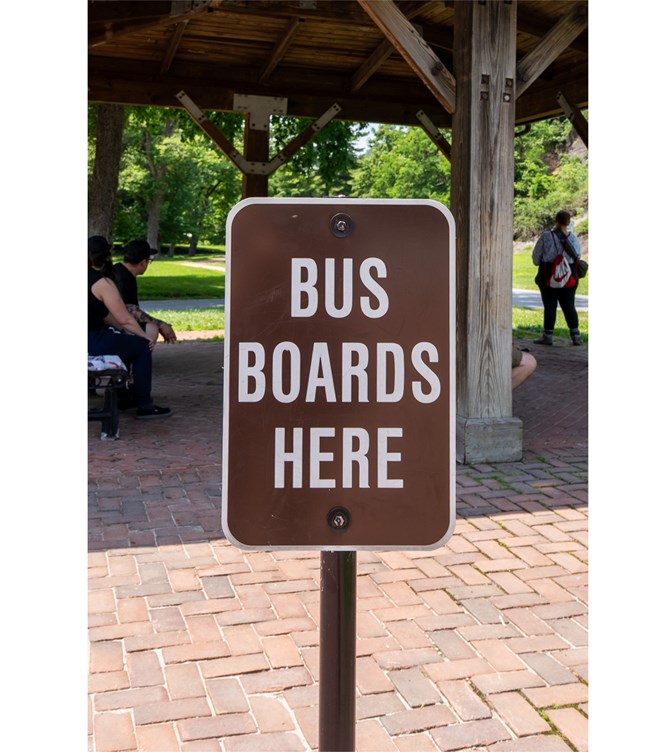 A sign that says "Bus Boards Here".