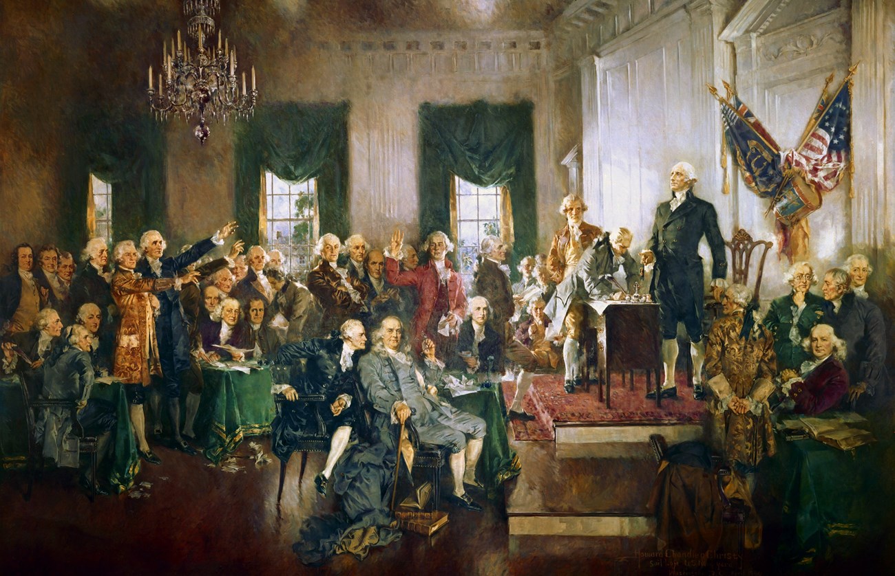 A painted image of a large group of men surrounded a document on a table, with one tall man at the head of the crowd.