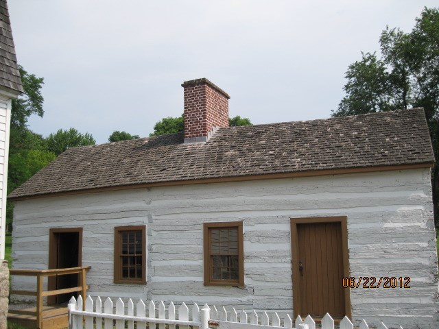 A white log cabin with 2 sides, like a duplex. This was quarters of the enslaved