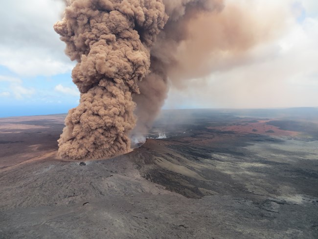 Large smoke plume emanating from a volcanic shield