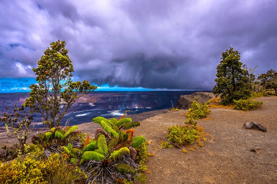 A volcanic crater degases under moody skies