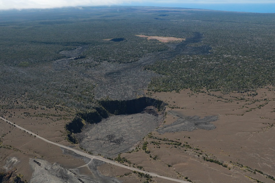 Aerial view of a volcanic crater and a road