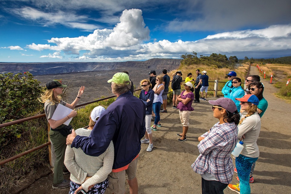 A ranger talks to visitors on the rim of Kīlauea Volcano