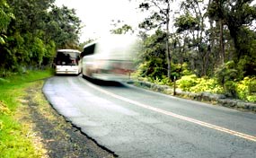 Two busses pass each other on Crater Rim Drive