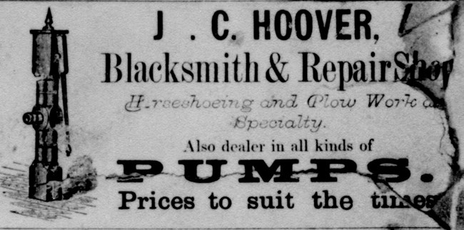 A blacksmith's 1877 newspaper advertisement proclaims horseshoes and plow work a specialty.