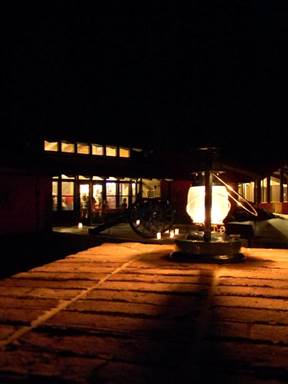 A kerosene lantern sitting in front of visitor center at night