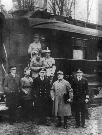 Armistice train Nine men in uniforms stand near the end of a train car