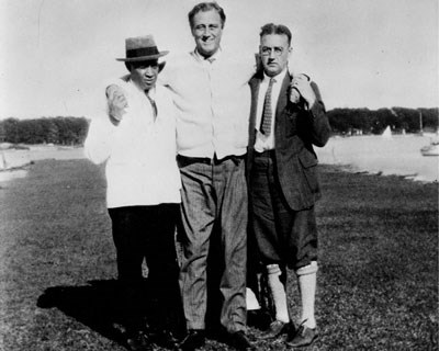 FDR standing with support of his valet Leroy Jones and Dr. MacDonald.