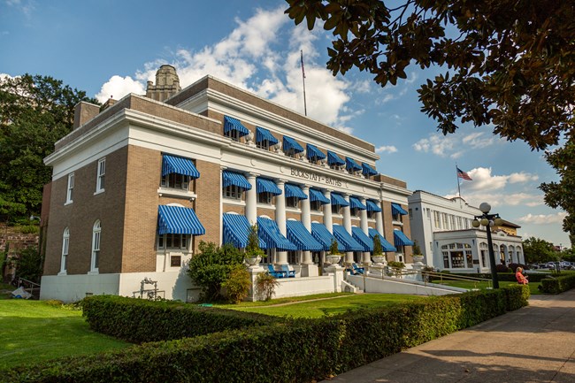 The front of the Buckstaff bathhouse on a sunny day showcasing its iconic bright blue awnings.