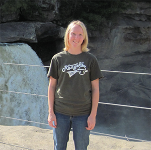 Clare Bledsoe standing in front of waterfal