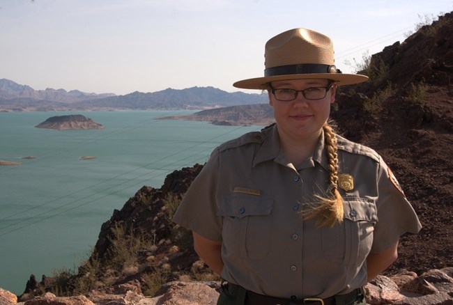 Jennifer Bailard, Physical Scientist Jennifer Bailard, Physical Scientist, in National Park Service uniform and with large lake in the background.