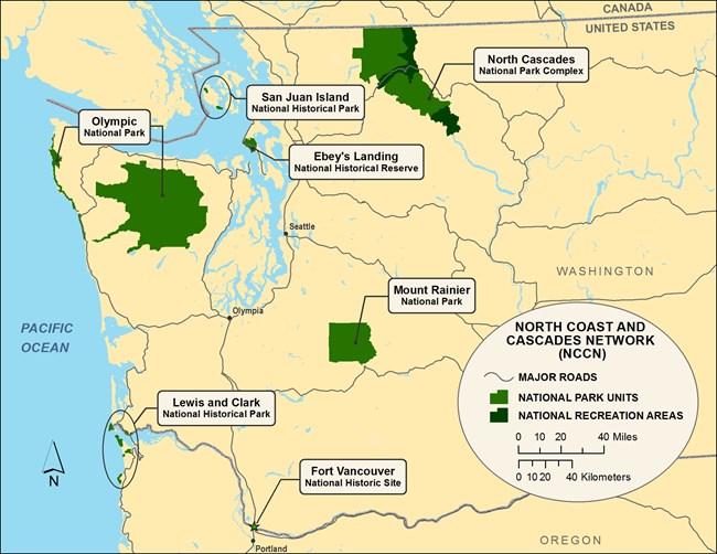 Basic map of western Washington and northern Oregon showing the 7 parks in the North Coast and Cascades Network as green polygons on beige background