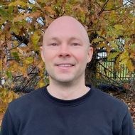 Portrait of smiling man in front of autumn tree