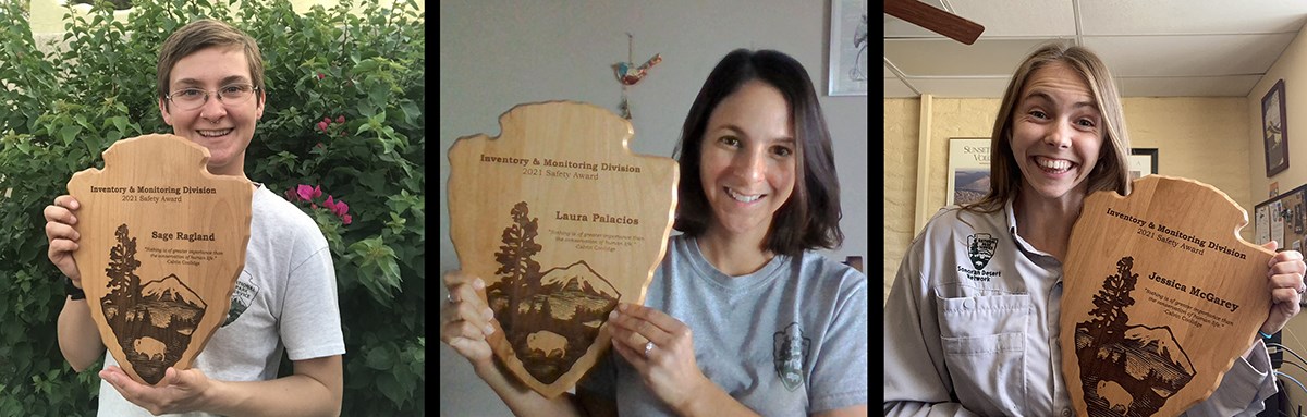 Safety award winners Three women hold arrowhead-shaped awards