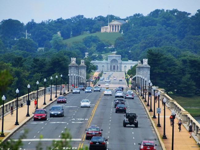 A view of Arlington Memorial Bridge looking towards Arlington Cemetary with the Robert E. Lee house at the top of the hill