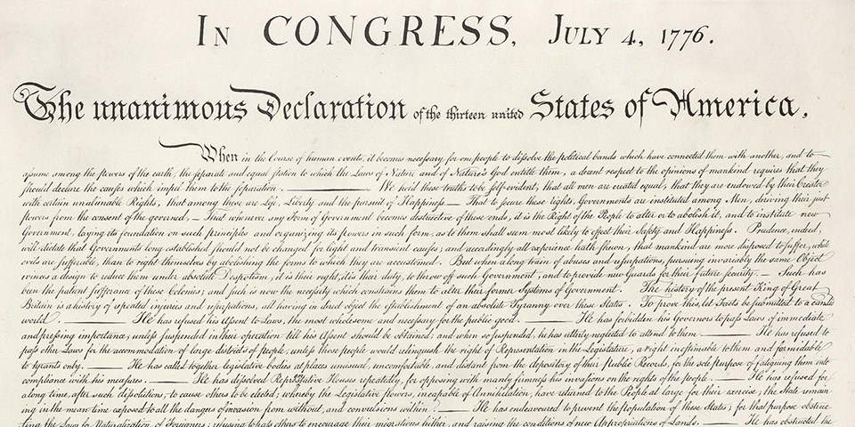 Color image of the top half of the handwritten Declaration of Independence with brown ink on cream paper.