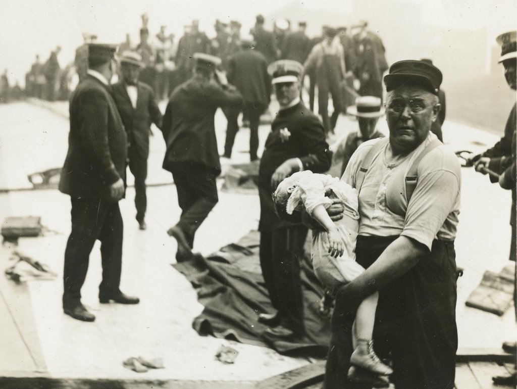 Jun Fujita's iconic photograph of the 1915 Eastland disaster; a grief-stricken man carries a lifeless child in his hands.
