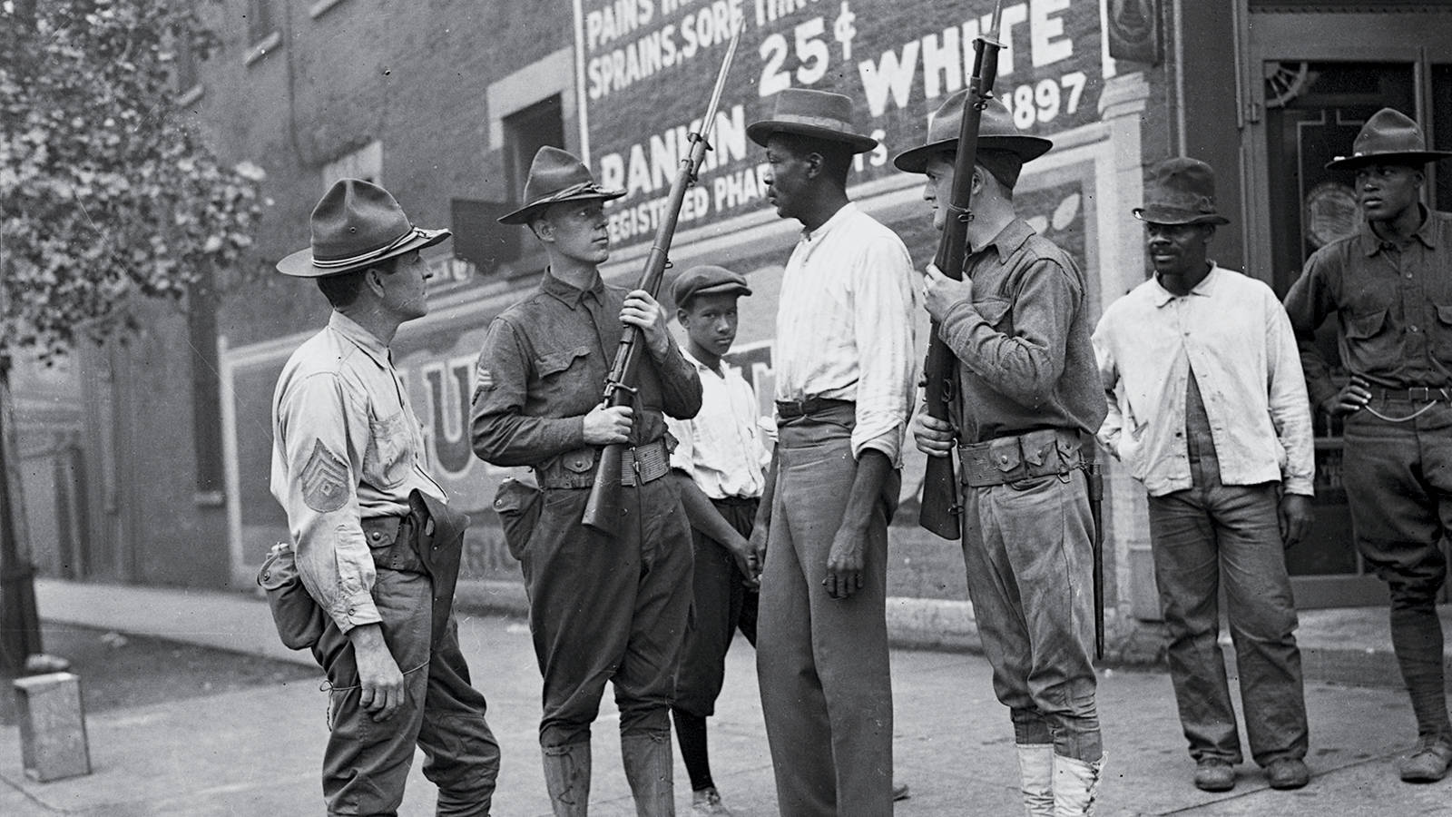 Jun Fujita's historic photograph of Illinois Army National Guard questioning a Black man during the racial violence that broke out in Chicago in 1919. 