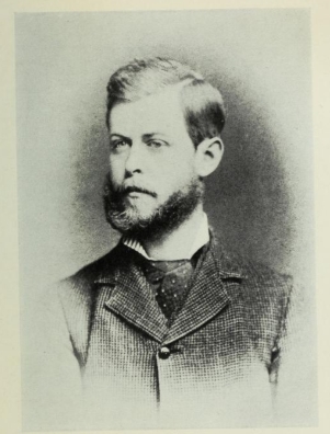 Young Henry Blake Fuller Portrait of a young man in a dark suit with a beard and mustache.