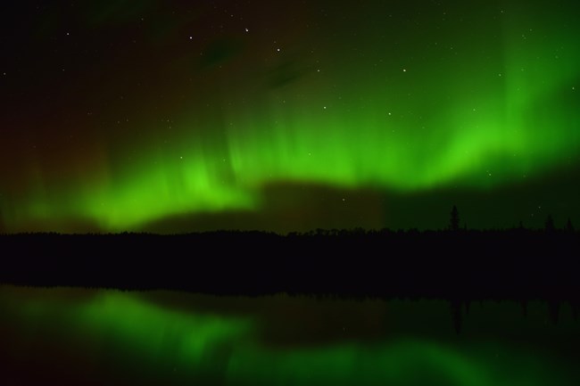 Northern lights with its green coloring across the night sky.