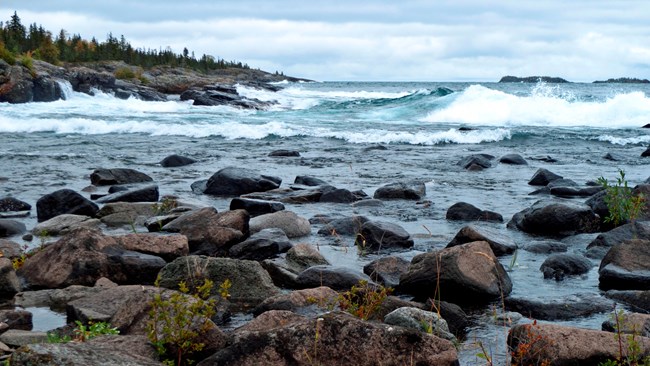 Lake Superior waves crashing on a rocky shoreline.