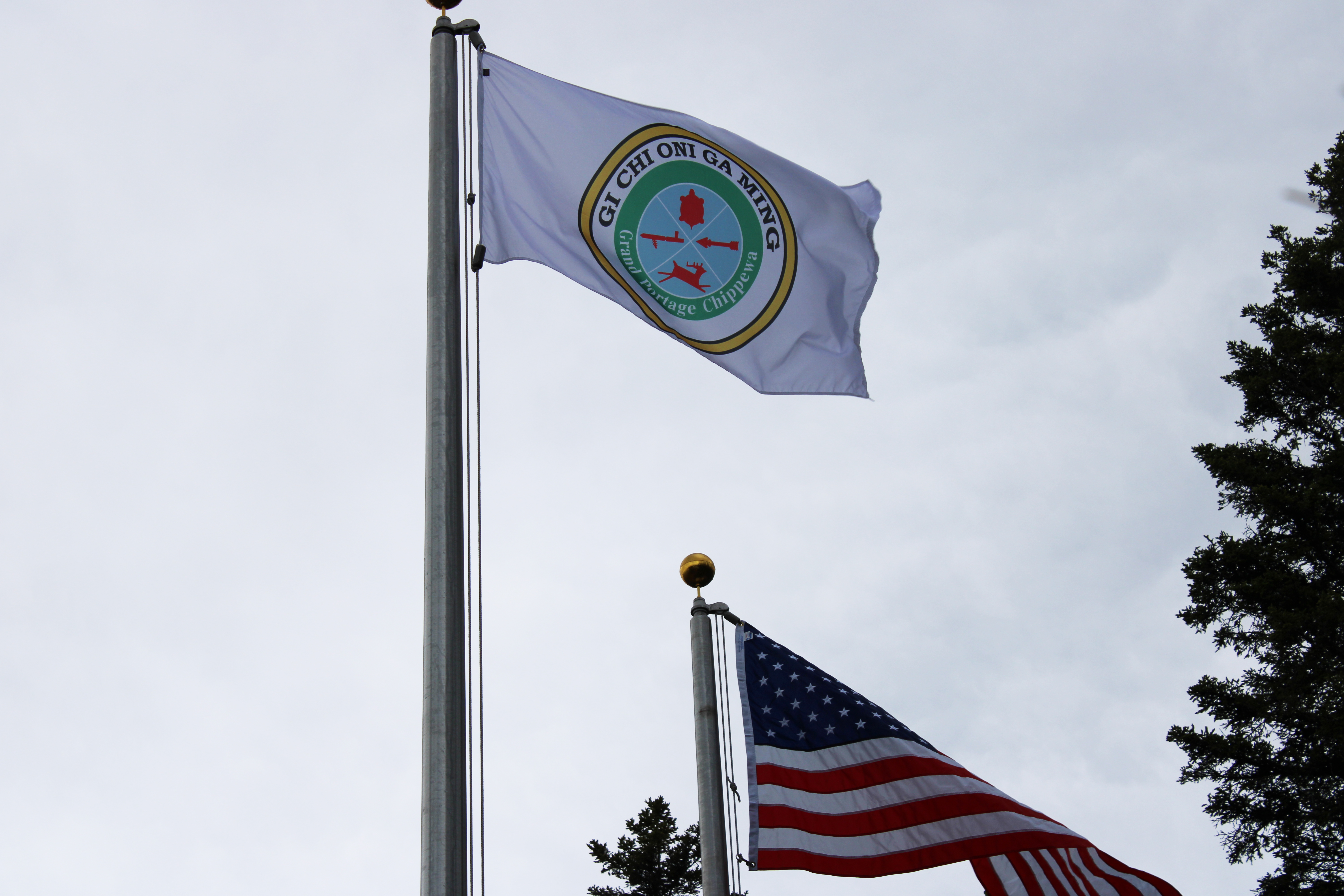 The flag of the Grand Portage Band of Lake Superior Chippewa flies next to the American flag.