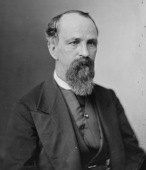 a man wearing a suit posing for a picture