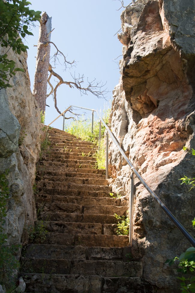 stone steps going up between two rock walls