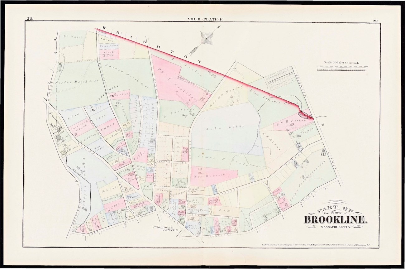 A colorful, ink drawn, paper map of part of Brookline in 1874. The areas of the map are divided into sections of pink, yellow, green, or blue ink. A bright red line separates the edge of the town from Brighton.