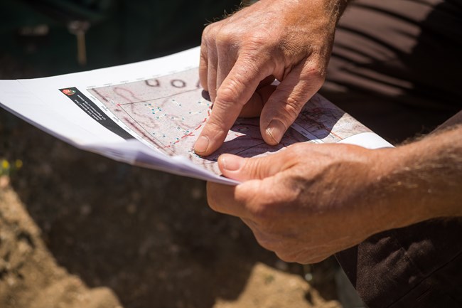 Close up of hands pointing at features on a map