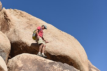 A scrambler on a steep rock face