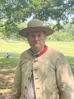 Man dressed in Confederate uniform standing outdoors
