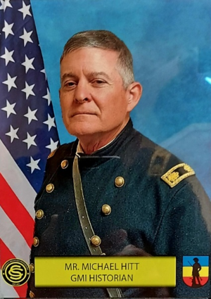 Man in Civil War uniform with American Flag behind.
