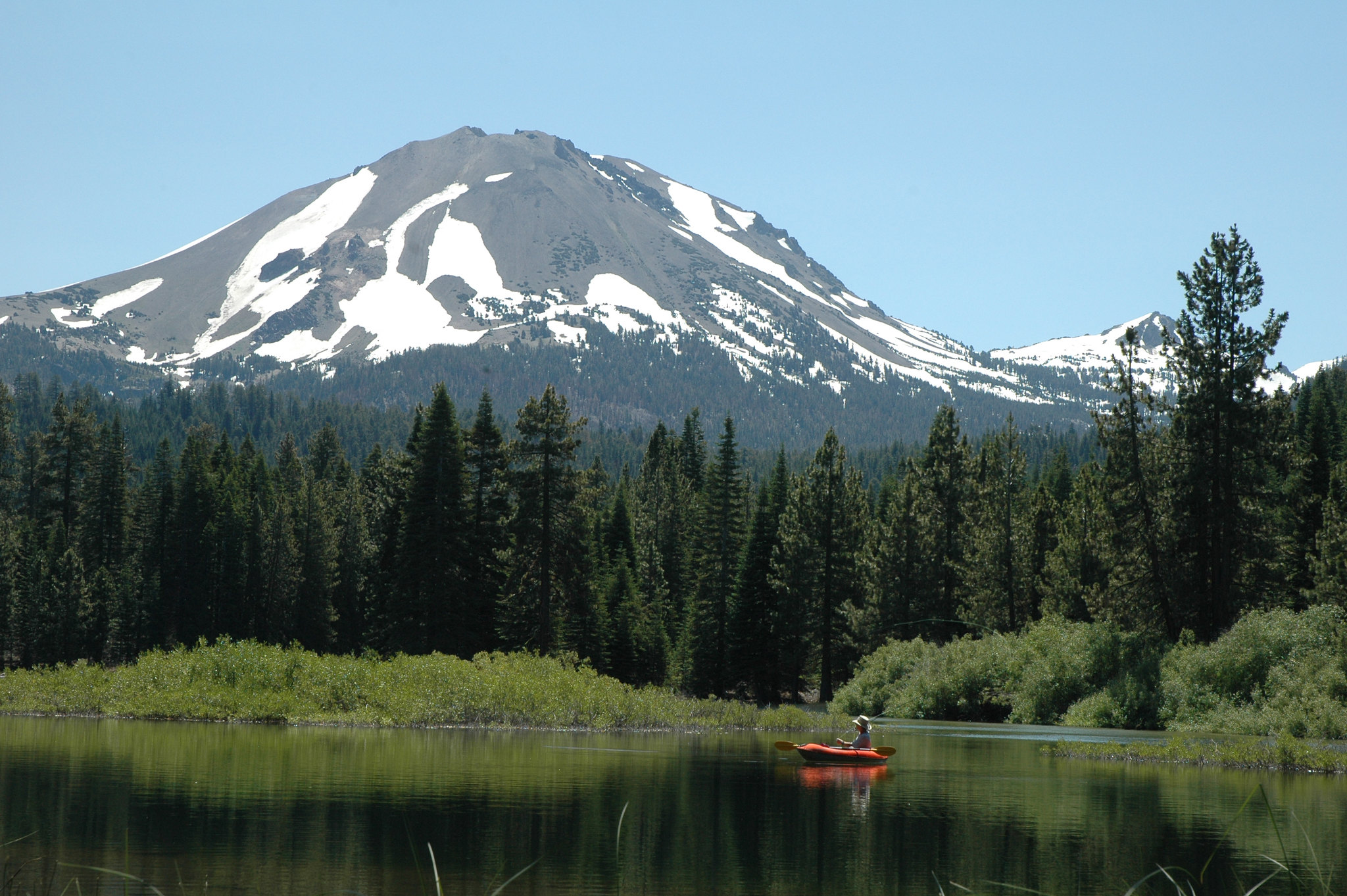 Solo kayaker on Manzanita Lake with Lassen Peak in the background