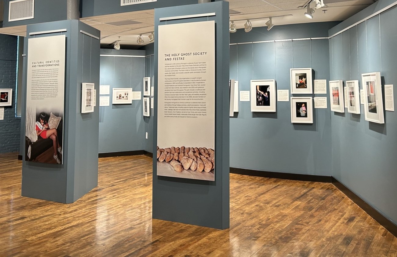 An exhibit space featuring large panels of text and photographs with labels