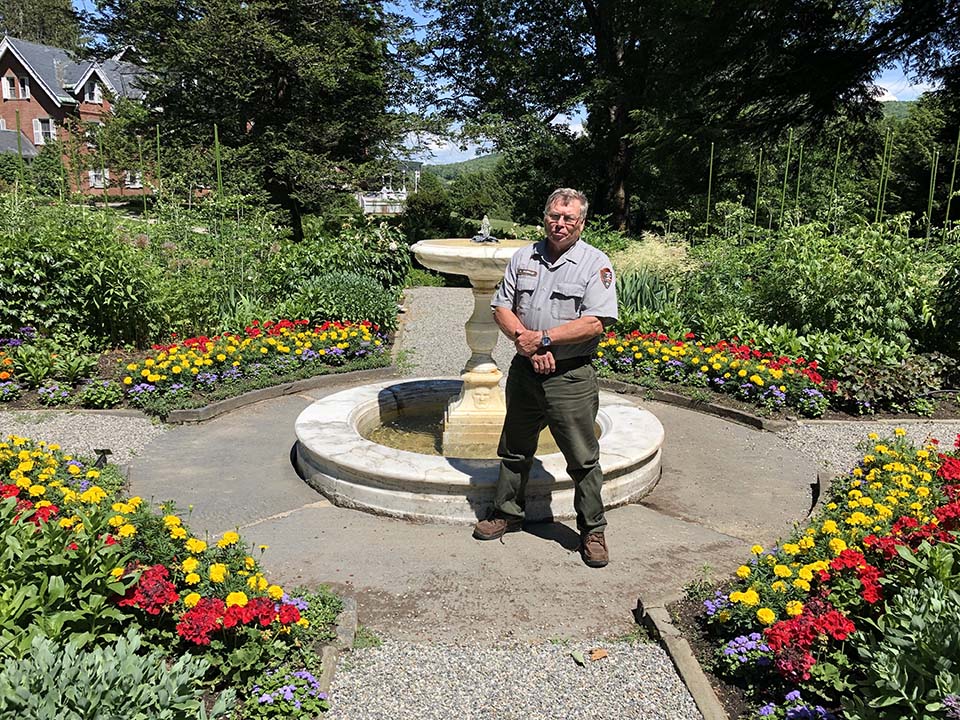 Kim Murray stands in formal garden