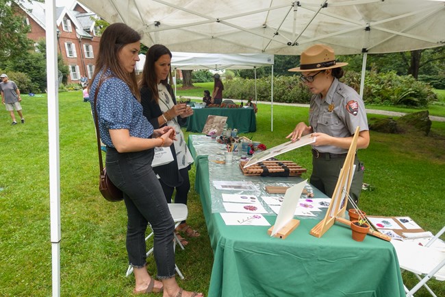 Herbarium print making A ranger shows two visitors an herbarium print.