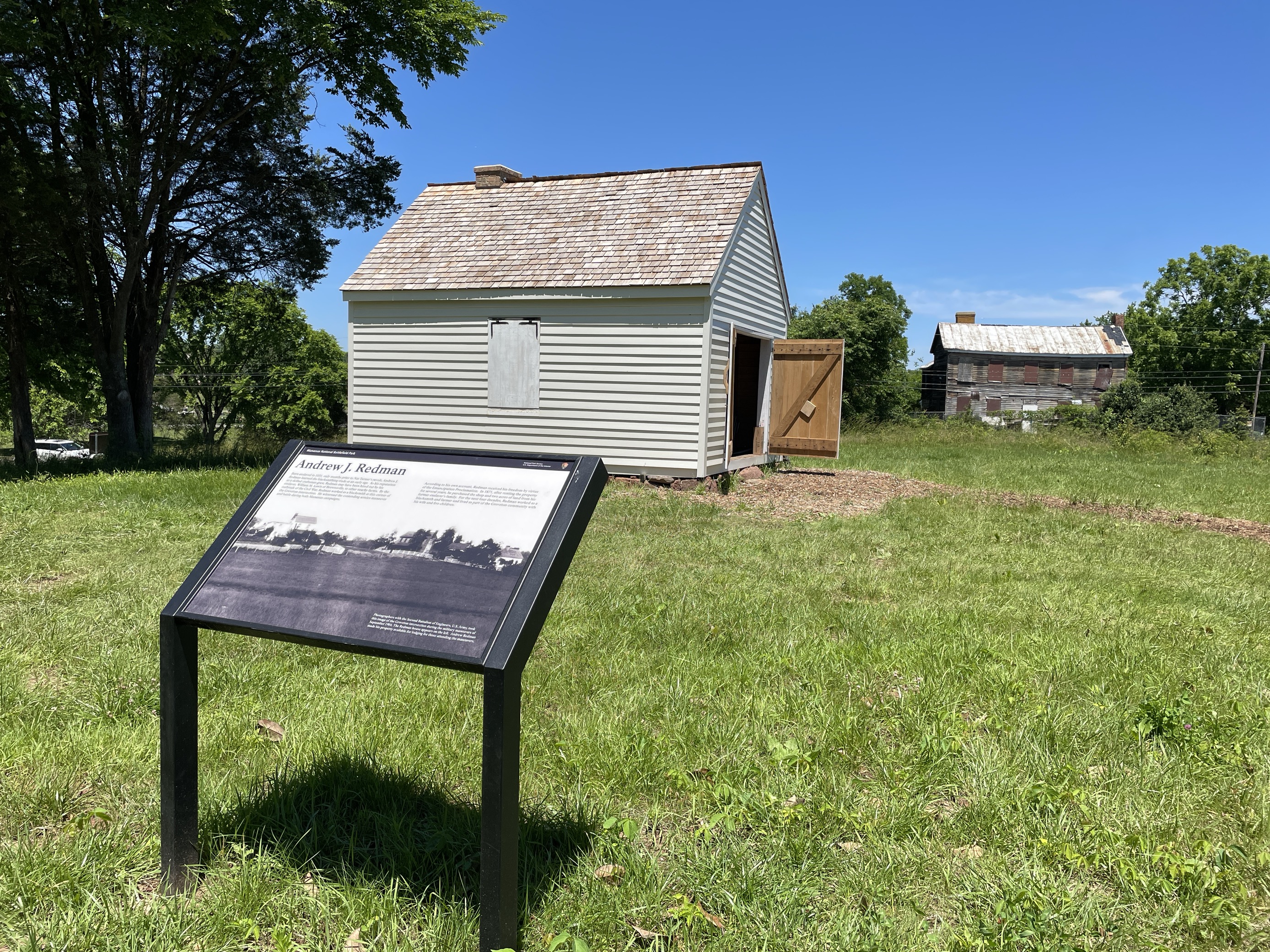 A white wooden barn-shaped structure.