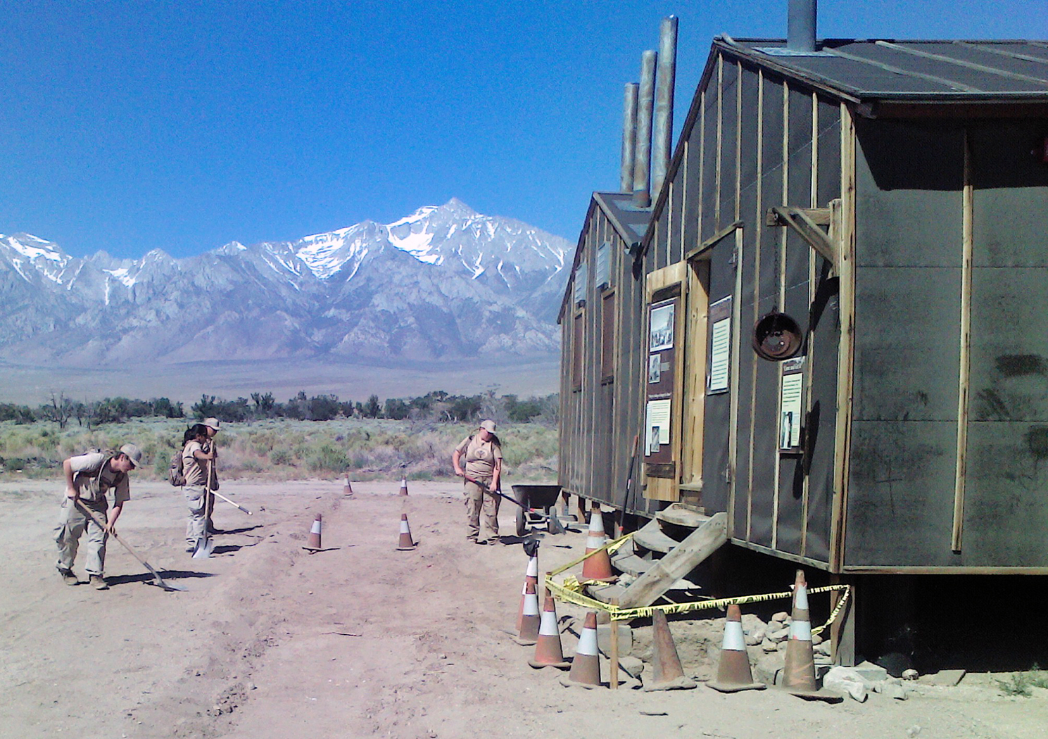 black building on right, sidewalk being installed along left by YCC crew