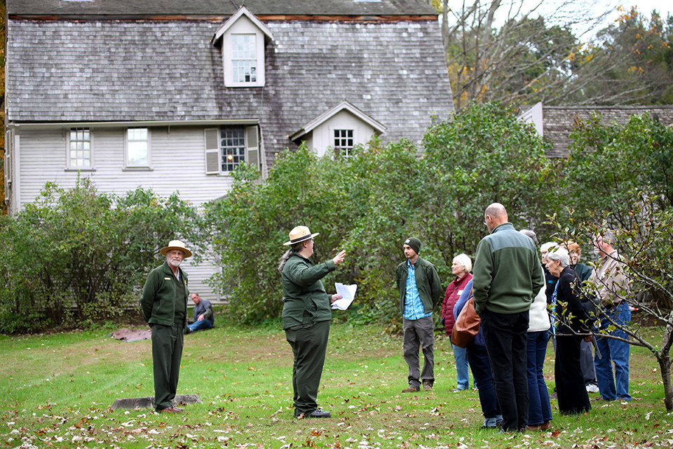 Rangers talk to visitors behind The Old Manse, Concord, MA