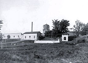 An old black and white photograph of the buildings and resevoir at the Bureau of Mines (Coldwater).