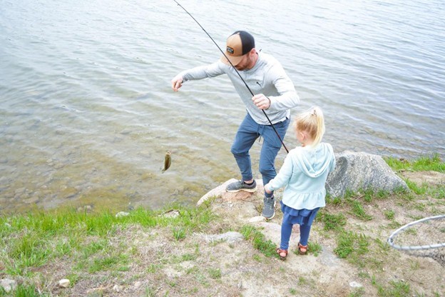 Father helping his daugher land a fish on the Missouri National Recreational River