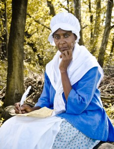 Dr. Daisy Century portraying first published enslaved African American, Phillis Wheatley Theater actress Dr. Daisy Century in a blue an white 18th century costume, portraying the first published enslaved African American, Phillis Wheatley.