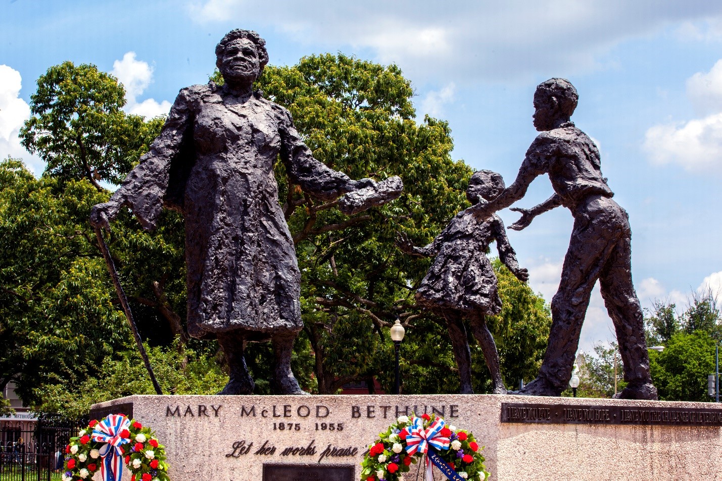 Image of the Bethune Memorial on a sunny day with wreaths places at the base of the memorial.