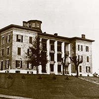 large three-story building on hillside