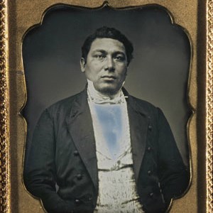 Black-and-white photo of Amos Haskins; gold frame.